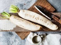 aerial-view-daikon-radish-wooden-cutboard-with-knife_53876-42876.jpeg