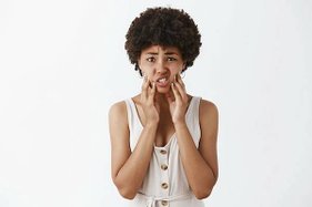 indoor-shot-displeased-upset-young-african-american-woman-with-afro-hairstyle-touching-face-frowning-feeling-bothered-with-pimples-acne-standing-disappointed_176420-23029.jpg
