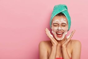 happy-joyous-young-girl-spreads-palms-face-washes-face-with-soap-has-fun-bathroom-pampers-skin-wears-wrapped-towel-head-expresses-positive-emotions_273609-33473.jpg