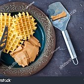 stock-photo-traditional-norwegian-breakfast-of-home-made-waffles-with-brown-cheese-or-brunost-served-on-a-357216044.jpg