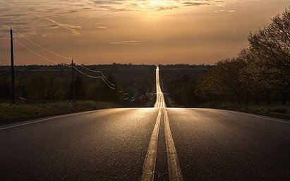 6976877-sunset-straight-road