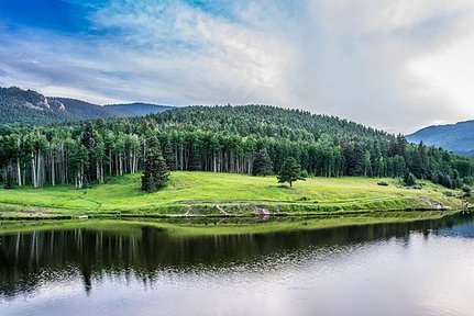 body-of-water-beside-green-leaved-trees-under-blue-cloudy-159884.jpg