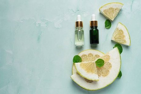 grapefruit-oil-serum-bottle-put-green-light-background_1150-28090.jpg