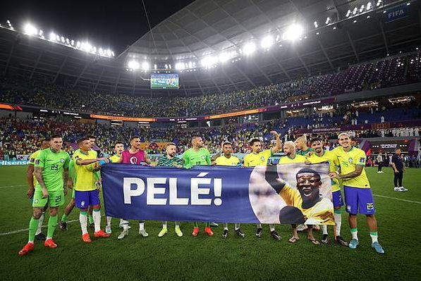 Brazil players hold a banner showing support for former Brazil player Pele after the World Cup match between Brazil and South Korea. (Hector VivasGetty Images).jfif