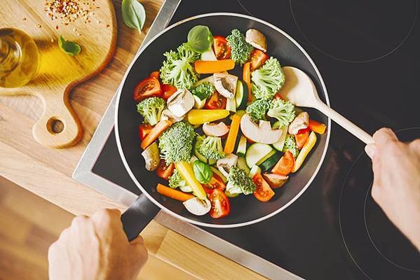 man-cooking-fresh-vegetables-pan