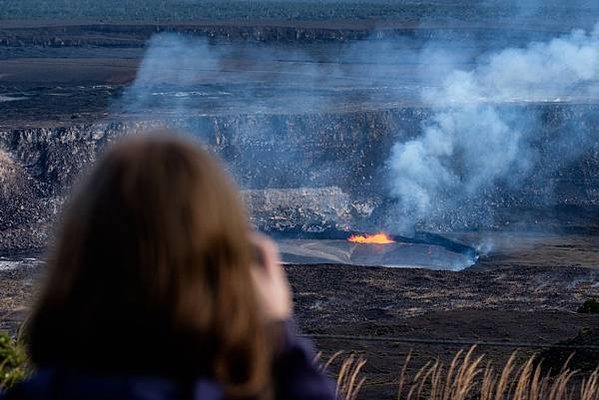 Woman taking a photo of a crater, Hawaii Volcanoes National Park, Island of Hawaii