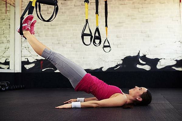 young-brunette-stretched-using-trx-trainer-smiling-woman-lying-sport-club-70345078