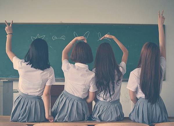 photo-of-four-girls-wearing-school-uniform-doing-hand-signs-710743