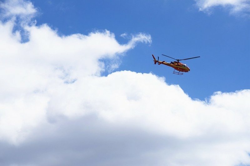 Mountain rescue helicopter hovering in the air (5)