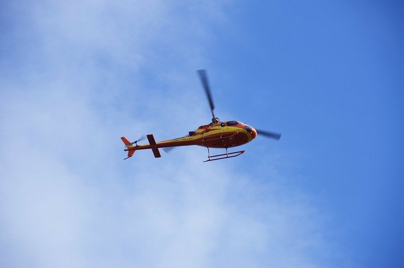 Mountain rescue helicopter hovering in the air (3)