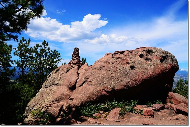 A built up stone post on the large rock at the summit