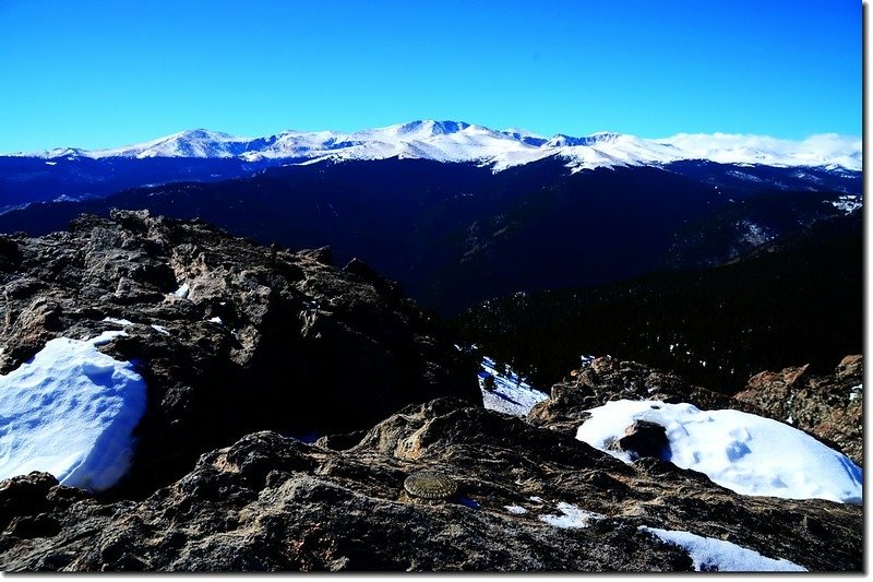 Chief Mountain Summit Marker, in the background are Mount Evans Massif