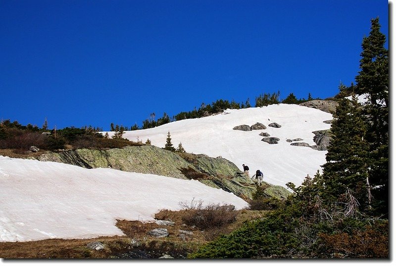 Two hikers making their way up this rock terrain