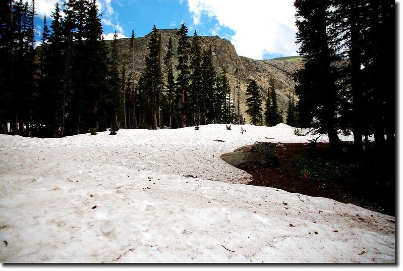 The trail to the lake was still covered in snow