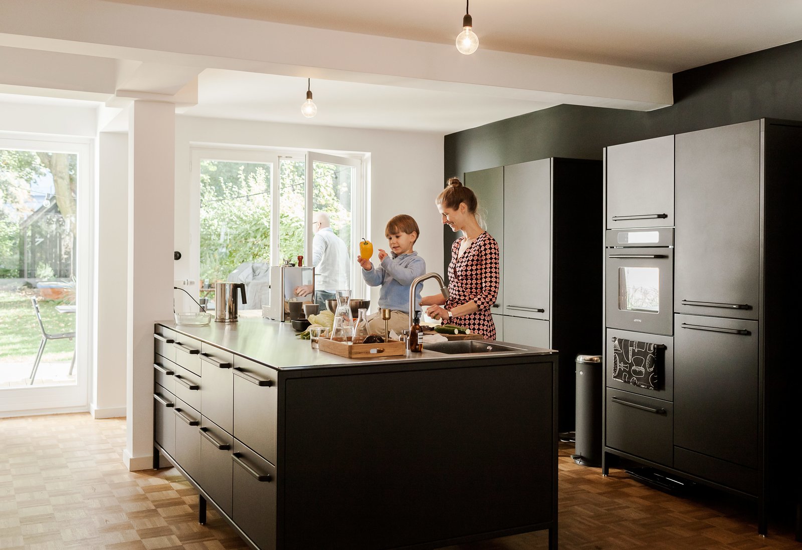 The island serves as a generous workspace for Dorothee to prepare dishes with her son Morten. The couple’s updates to the 1967 apartment included introducing large windows to the garden and covering the floors with an oak parquet to match the original flooring in a couple of rooms.