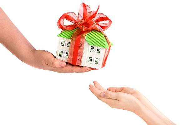 Adults-Hand-Giving-Childs-Hands-a-Model-of-the-House