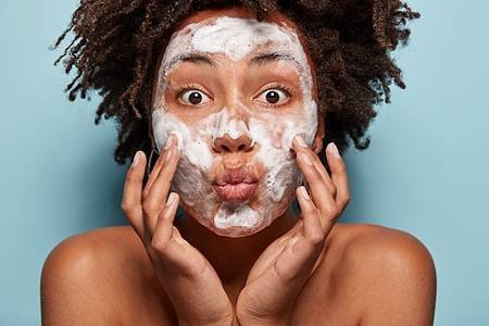 people-wellness-hygiene-skin-problems-concept-lovely-afro-american-lady-keeps-lips-folded-touches-cheeks-has-white-foam-faces-washes-with-beauty-gel-feels-refreshed-has-wide-opened-eyes_273609-26528.jpg