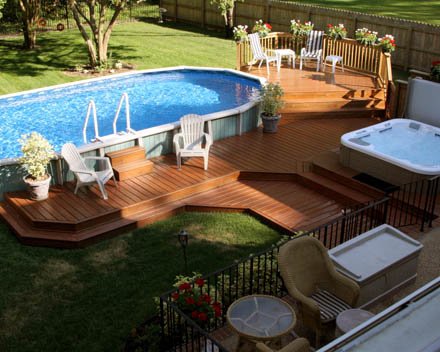 Oval-above-ground-pool-deck-off-house-with-outdoor-furniture.jpg