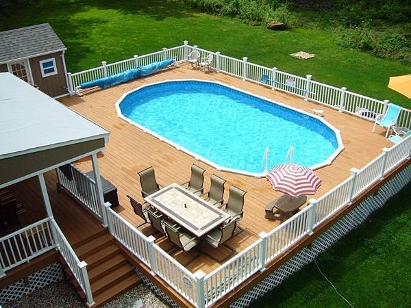 Oval-above-ground-swimming-pools-with-wooden-decks-and-white-railing.jpg