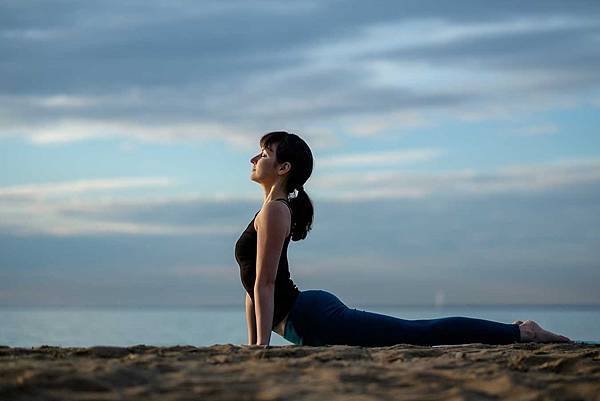 yoga-asana-outdoors-on-beach-up-facing-dog-pose-P77BCRU.jpg