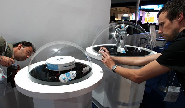 Visitors take photographs of Game maker Level 5&apos;s game console Roid during the Tokyo Game Show 2008.bmp