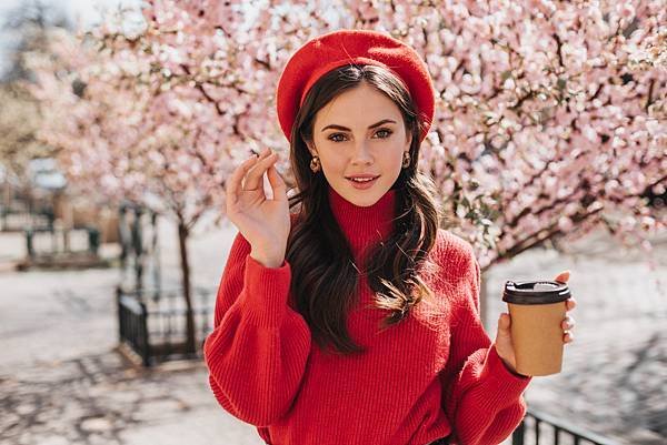 attractive-lady-red-sweater-walks-along-avenue-with-sakura-drinks-coffee-beautiful-woman-beret-smiling-enjoying-tea-outside.jpg