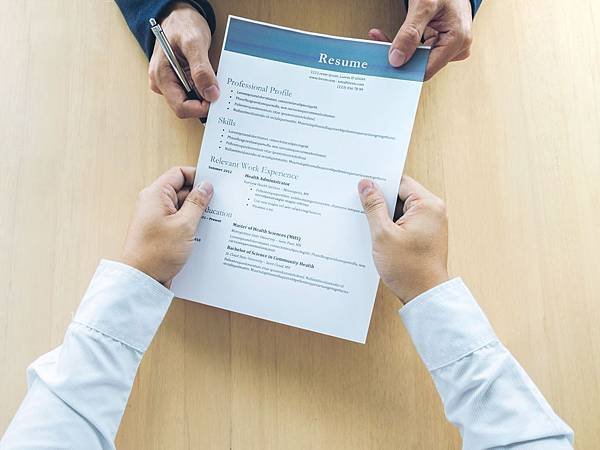 cropped-hands-of-business-people-holding-resume-on-table-in-office-944152896-5af32eb3ff1b7800204fa3d0