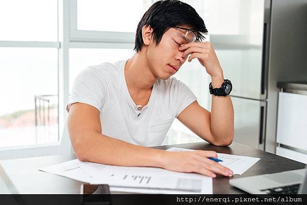 graphicstock-tired-asian-man-by-the-table-with-docements-and-laptop_HO1Jufwhe.jpg