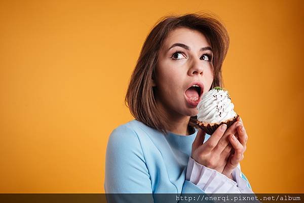 graphicstock-cute-lovely-young-woman-eating-sweet-cake-over-yellow-background_rubkuPCIhe.jpg