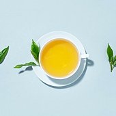 green-tea-brewed-cup-with-tea-leaves-blue-pastel-background-top-view_1220-5336.jpg