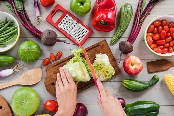 close-up-person-s-hand-cutting-cabbage-with-knife-chopping-board-surrounded-with-vegetables-table_23-2148165568.jpg