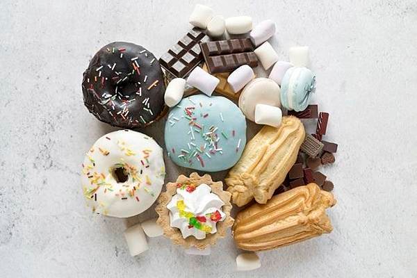 elevated-view-various-confectionery-food-white-cement-textured-backdrop_23-2148193063.jpg