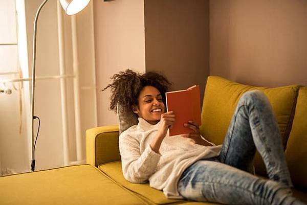 2_getty_rf_woman_on_couch_reading_book.jpg