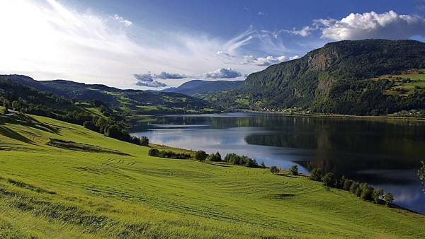 Lake-water-fields-grass-greenery-hills-mountains-summer-clouds_2560x1440