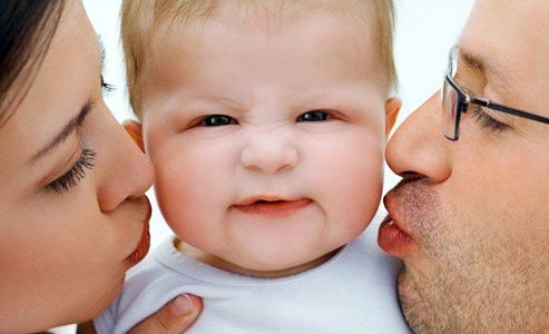 getty_rf_photo_of_parents_kissing_infant-493x300.jpg