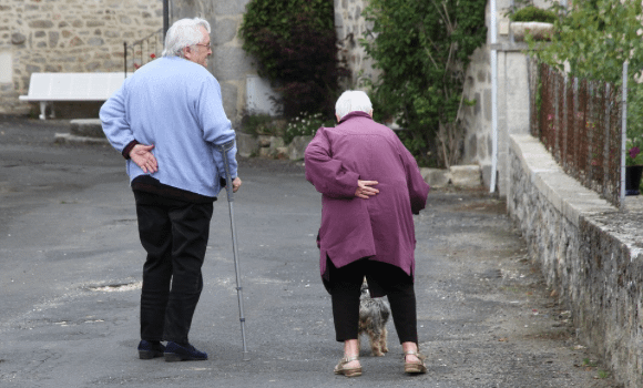 Image-of-an-elderly-couple-supporting-their-backs-and-walking-with-canes.-.png