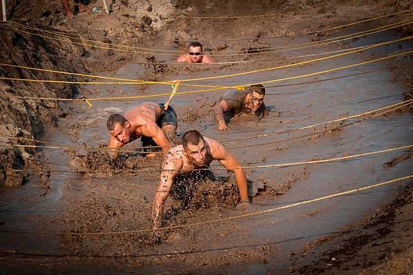 US_Navy_110813-N-XS652-351_Runners_navigate_an_obstacle_during_the_11th_annual_Armed_Services_YMCA_Mud_Run_at_Joint_Expeditionary_Base_Little_Creek