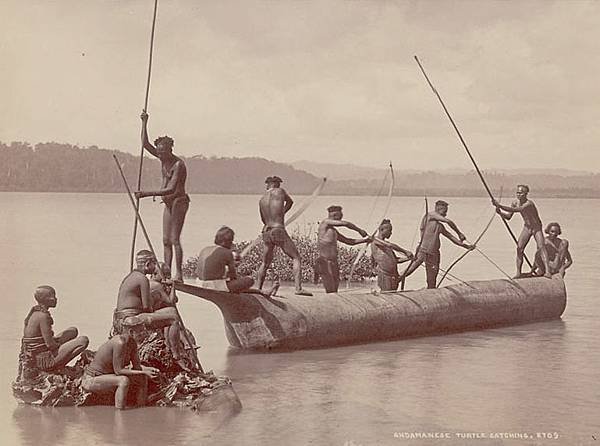 Group_of_Andaman_Men_and_Women_in_Costume,_Some_Wearing_Body_Paint_And_with_Bows_and_Arrows,_Catching_Turtles_from_Boat_on_Water