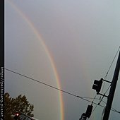 It&apos;s rainbow in front of the gray sky.