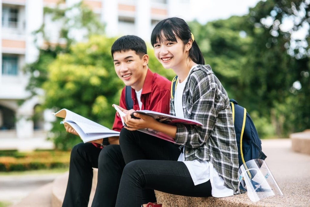 male-female-students-sitting-reading-books-stairs.jpg