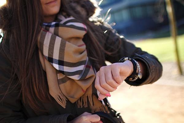 young-woman-checking-time-in-park.jpg