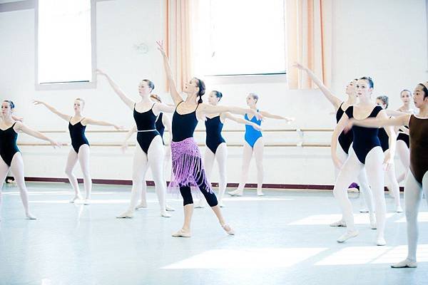 Ballet teacher teaching combination