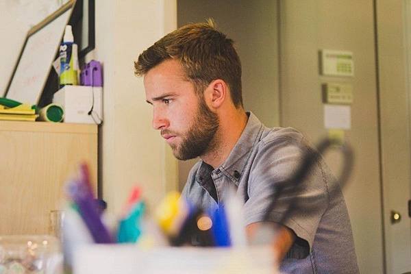 young-man-sitting-and-working-at-desk.jpg