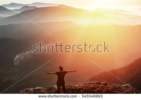 stock-photo-man-on-top-of-mountain-celebrating-succes-trip-concept-545549893.jpg