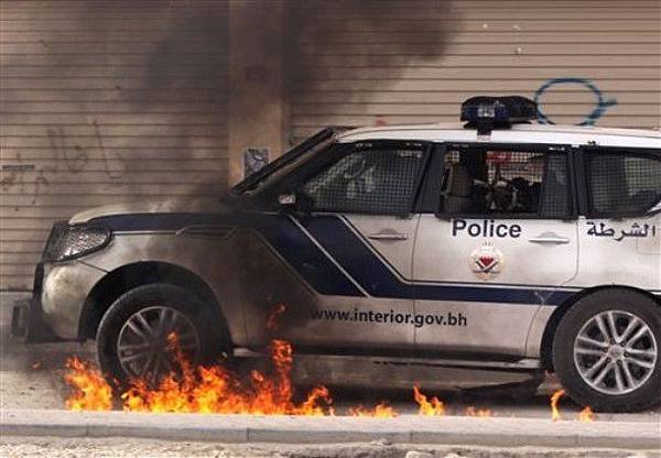 Riot police vehicle drives through a fire from a petrol bomb from anti-government demonstrators, during clashes Saturday