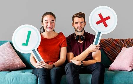 cheerful-couple-holding-vote-icon-sitting-on-a-couch_53876-24976.jpg