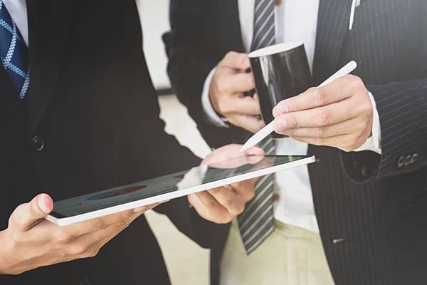 man-in-black-suit-holding-white-tablet-computer-3740419.jpg